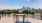 a table and chairs on a deck overlooking a city