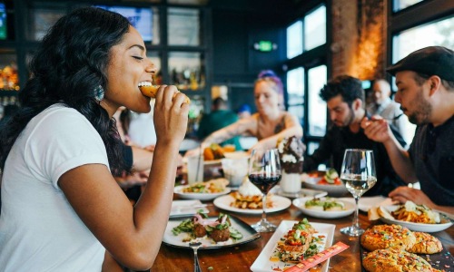 a group of people eating at a restaurant