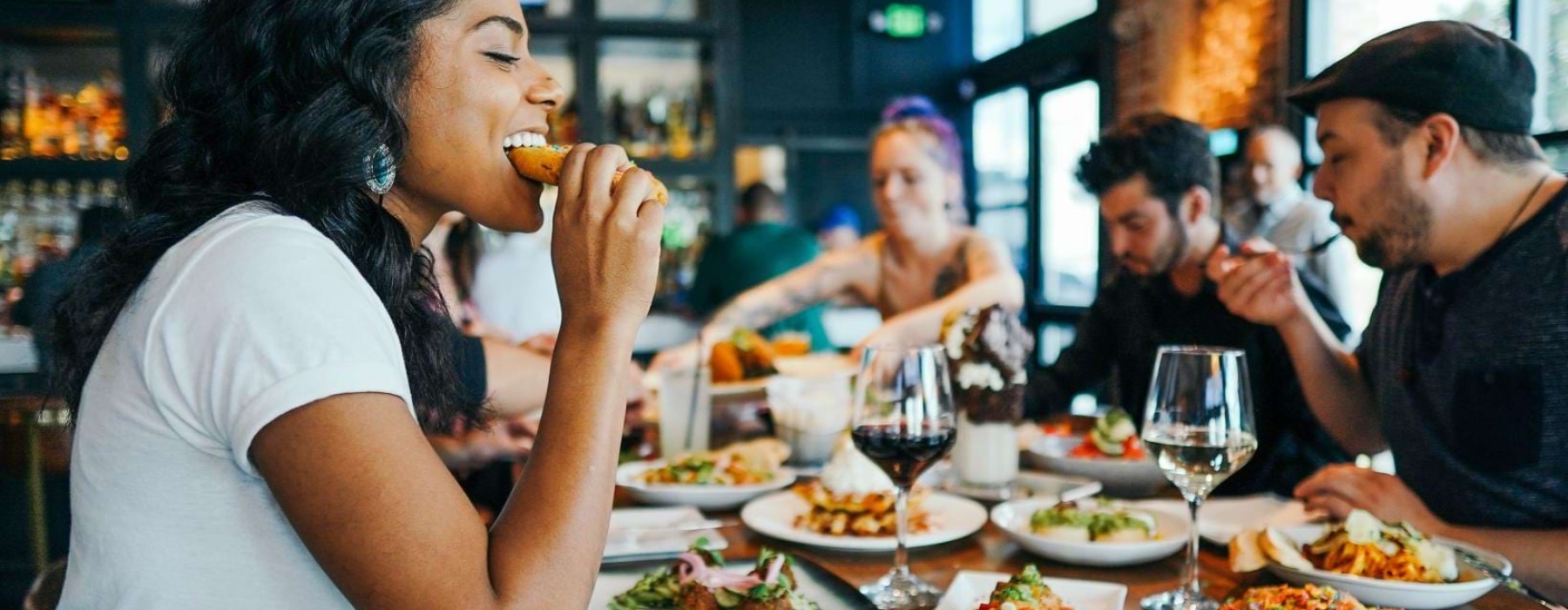 a group of people eating at a restaurant