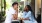 a man and woman sitting at a table outside