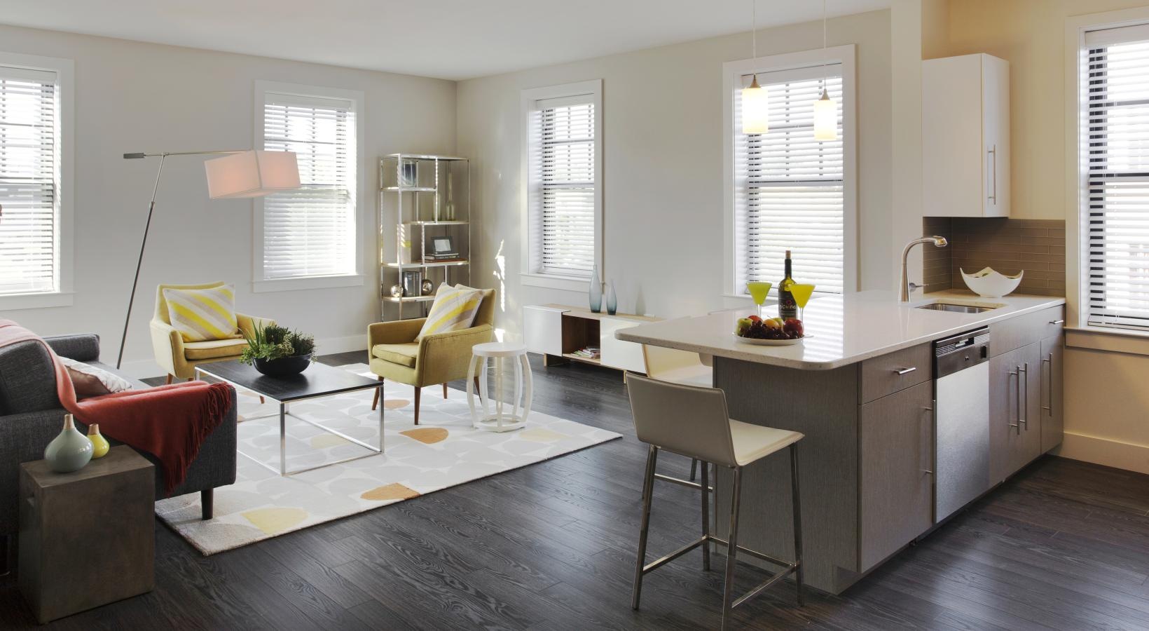 Relax and unwind in well-lit living areas a kitchen with a table and chairs