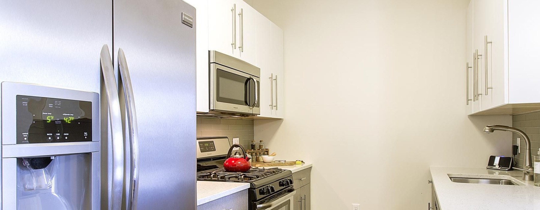 a kitchen with a refrigerator and microwave