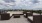 a deck with chairs and a view of a city