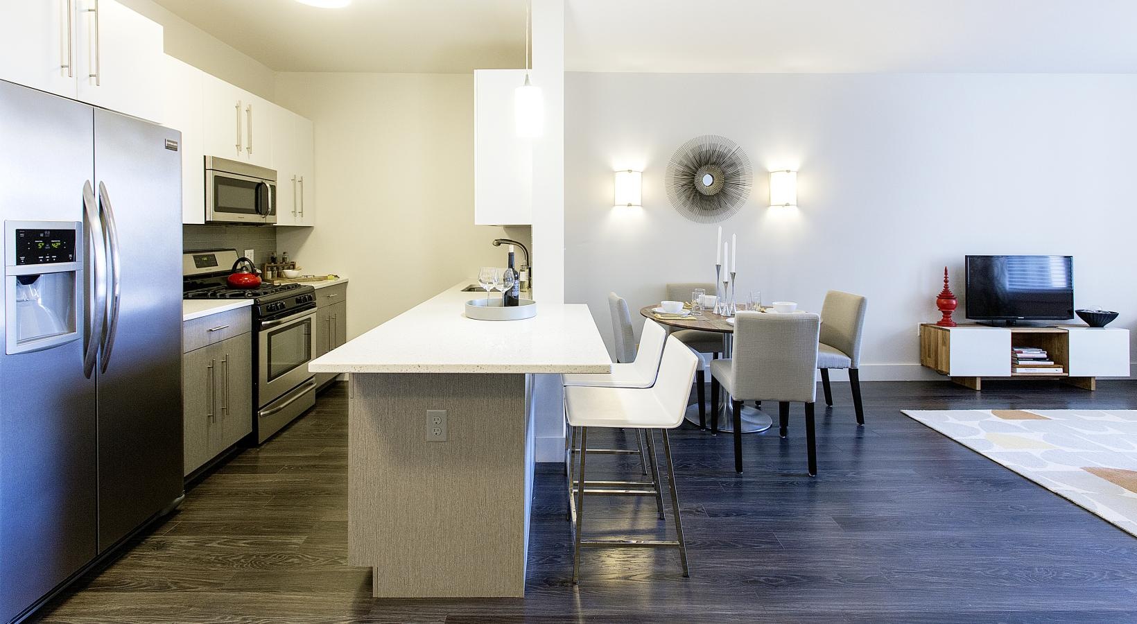 Beautiful kitchens with designer finishes a kitchen with a table and chairs