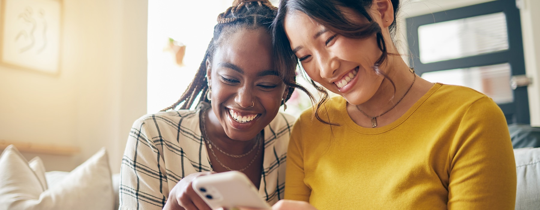 two ladies looking on a smart device