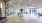 a large room with a large glass wall and a table with a plant on it